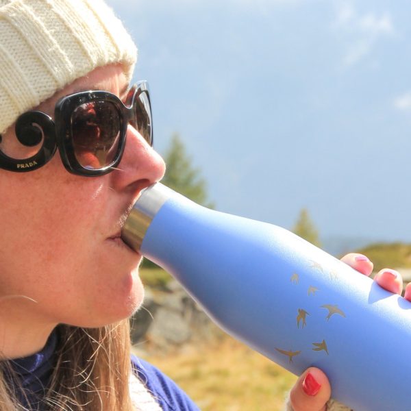 Ohelo blue swallow bottle, woman drinking