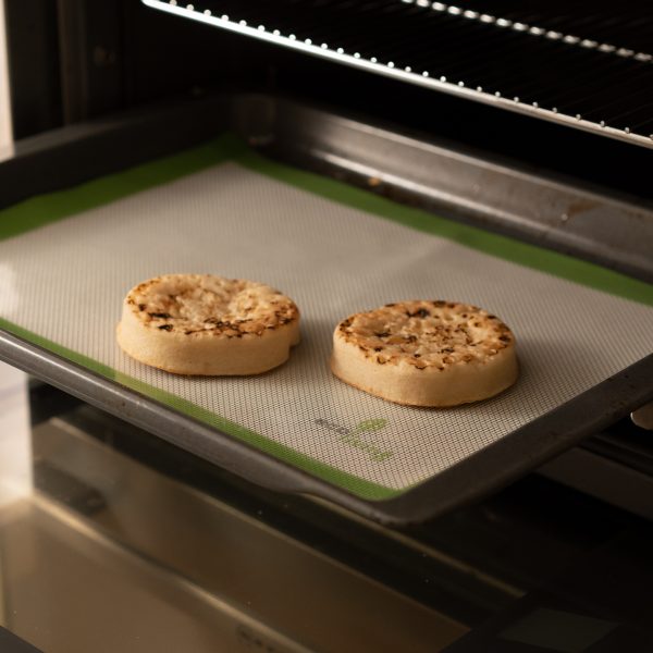 Reusable baking mat with crumpets in oven